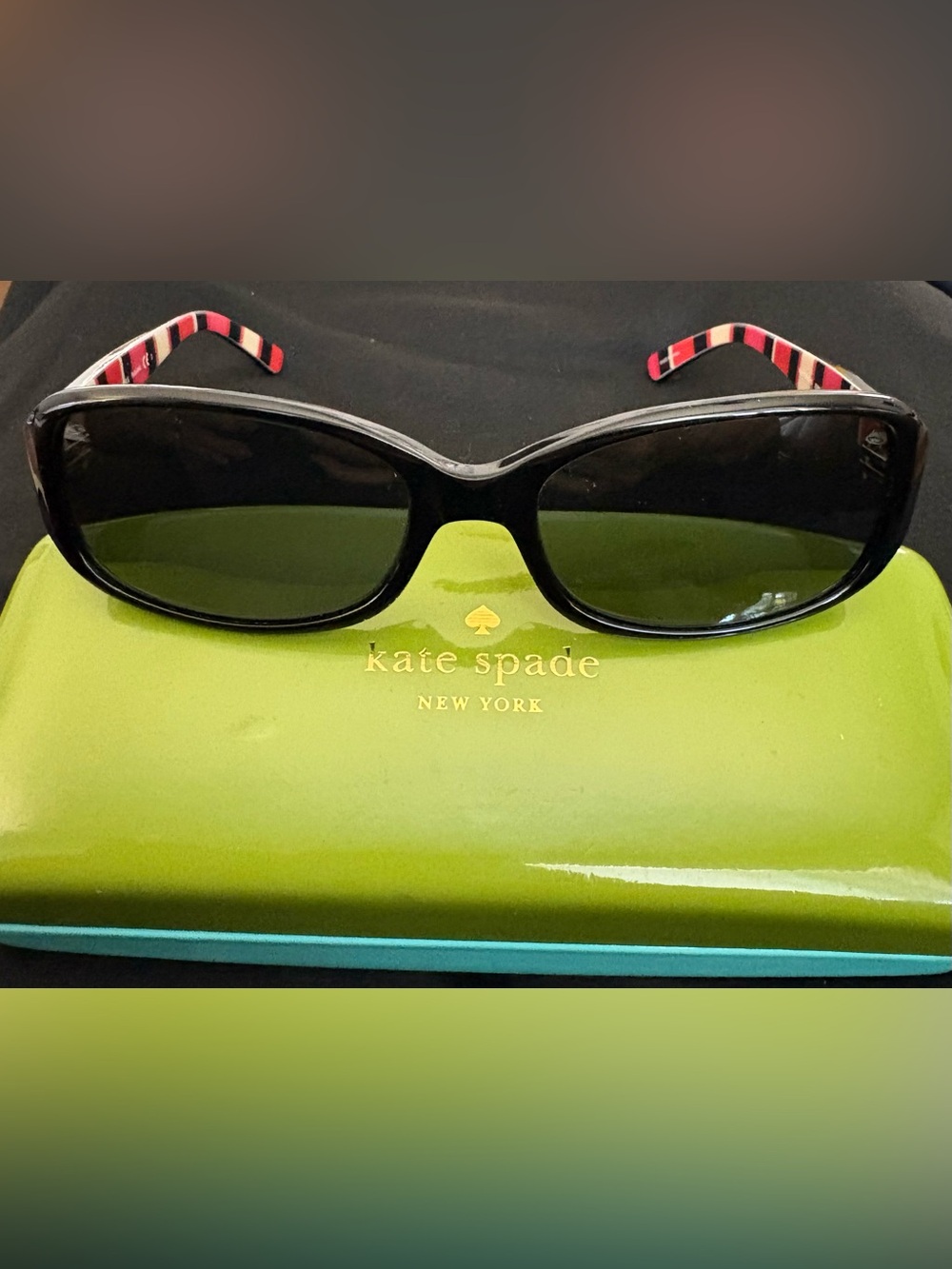 kate spade Black Frame Sunglasses with red Stripe Temples. Hard case and cloth